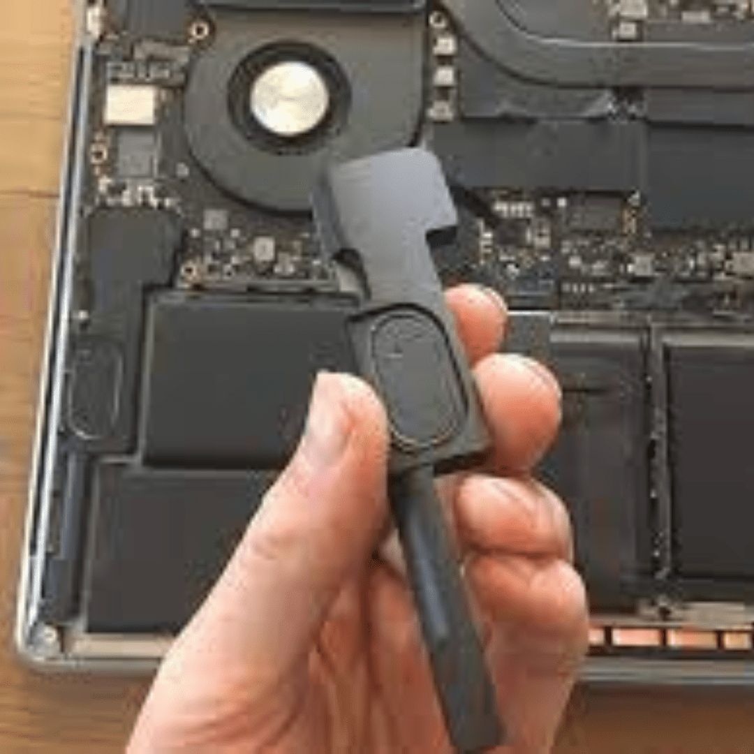 A technician with anti-static gloves replacing internal speakers on an open MacBook, with precision tools arranged on a clean workspace.