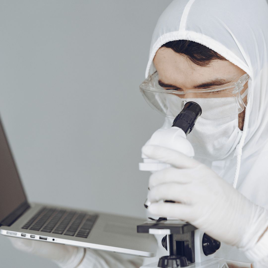 Technician performing a detailed diagnostic check on a MacBook Pro at iCore Dotcom's service center.