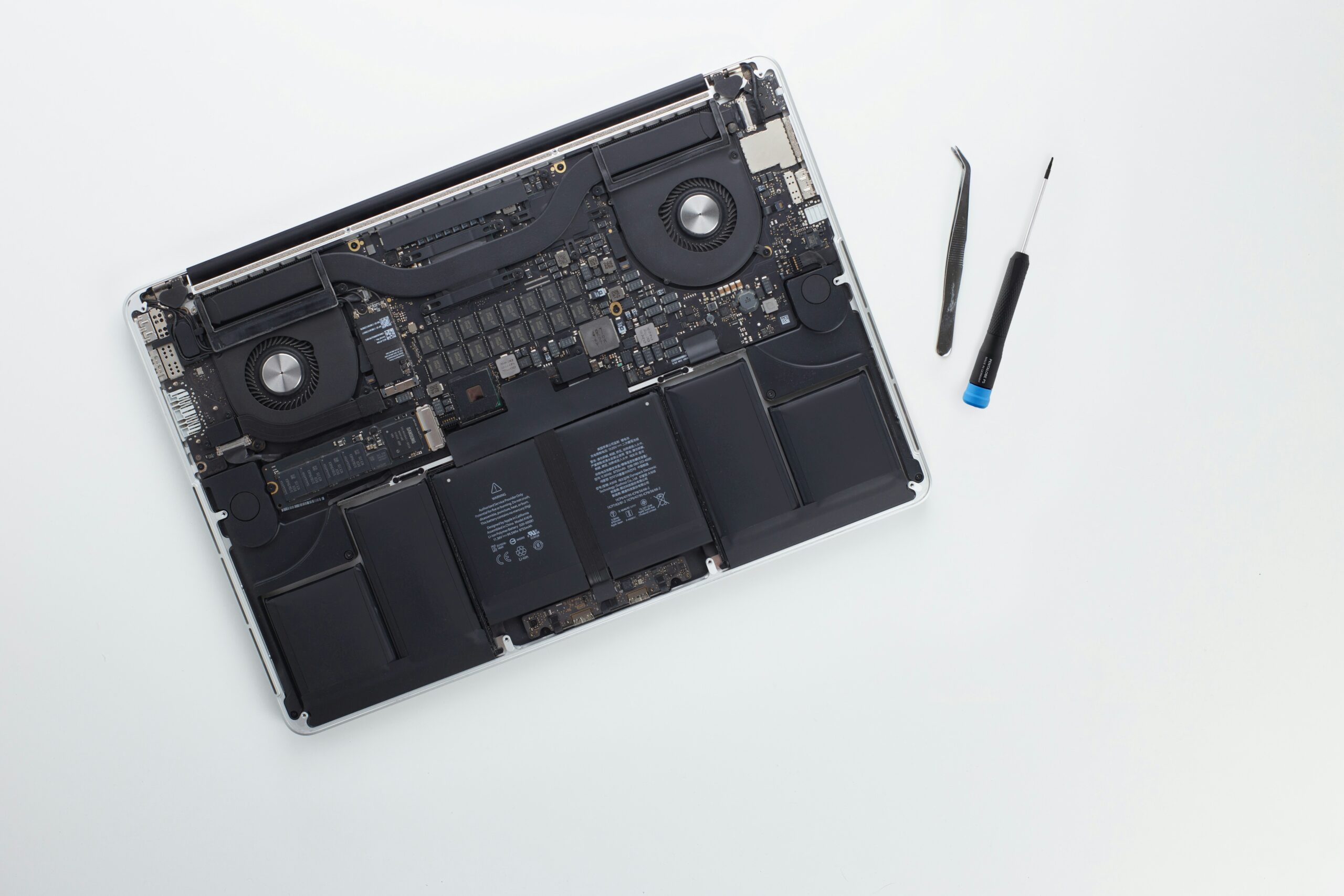 Close-up photo of a MacBook logic board showcasing detailed circuitry and components.